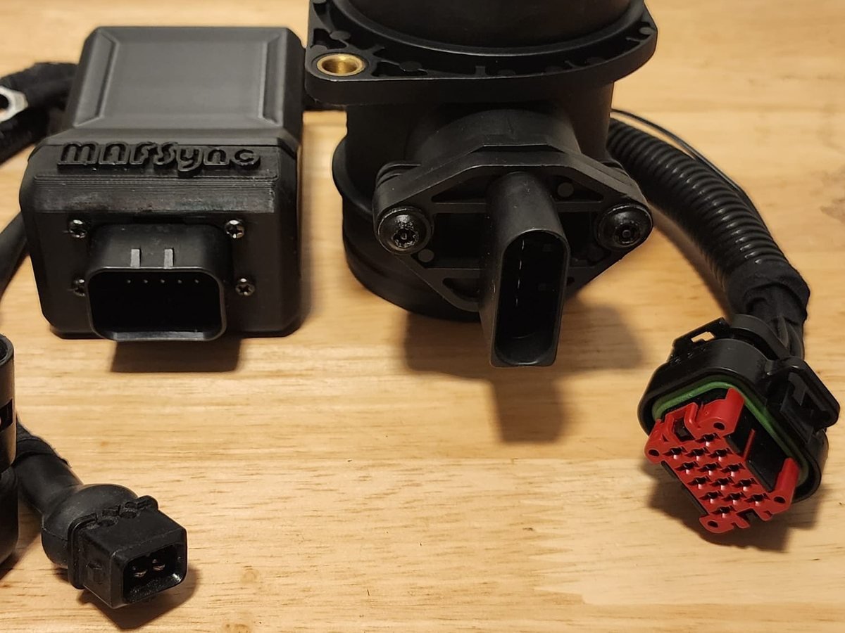 MAFSync module with its sealed 14-pin connector next to the HFM5 MAF sensor and harness plugs